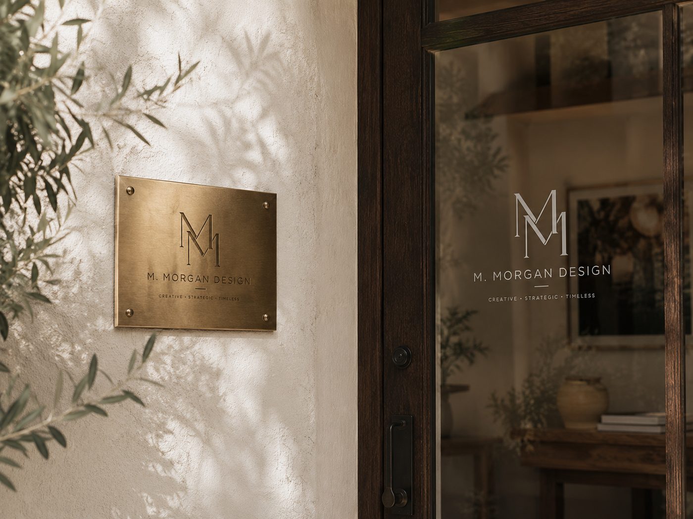 M. Morgan Design logo applied to a brass studio plaque and glass door
